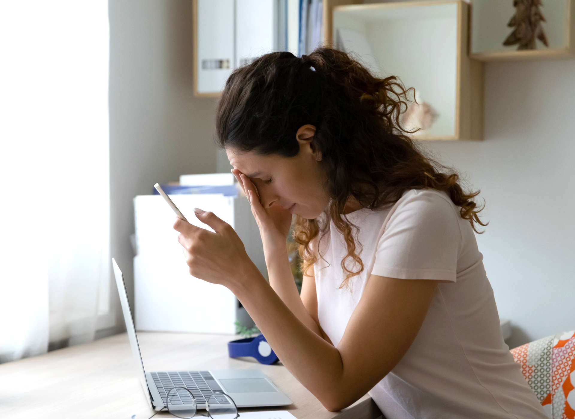 Stressed out woman looking at a laptop